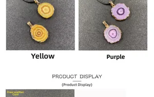 Macro detail of yellow and purple crystal slice pendants with gold plated edges on leather cord