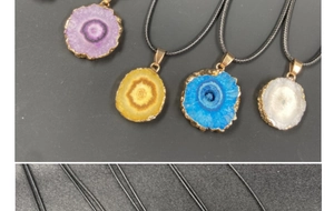 Macro detail of natural crystal flower pendants with electroplated gold edges and textures