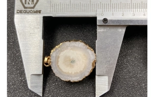 Macro view of crystal sunflower pendant diameter measurement with golden plated edge