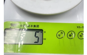 Macro detail of kitchen scale LCD display and function buttons on white plastic body