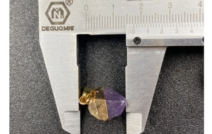 Detail view of amethyst stone pendant length measured at 23mm with digital caliper