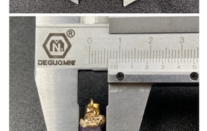 Macro detail showing natural purple crystal pendant width measured at 10.5mm with a caliper