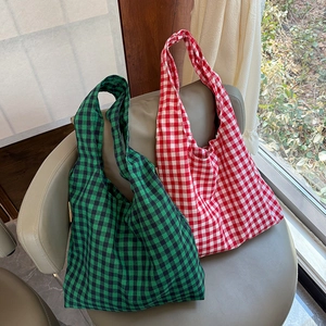 Retro plaid tote bag in green and red cotton fabric on a chair with natural light