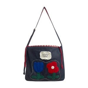 Navy blue denim tote bag featuring floral tulip embroidery and white ruffle detail