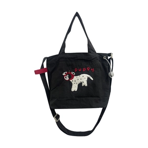 Black nylon crossbody bag featuring cute white puppy embroidery and red puppy text