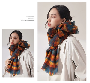 Detailed view of checkered scarf with vintage orange and navy plaid and fringe edges