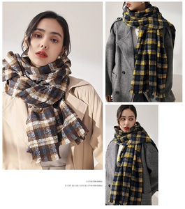 Detailed view of thick plaid scarves with tassels in classic yellow and brown patterns