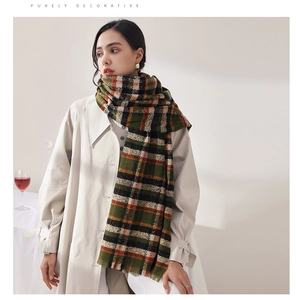 Detailed view of the plaid pattern and fringe trim on this thick autumn winter scarf