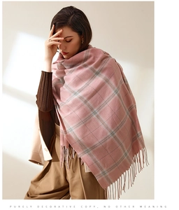 Detail of pink plaid pattern and soft tassel edges on the cashmere-feel winter scarf