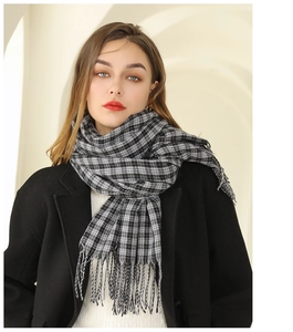 Écharpe classique à carreaux noirs et blancs avec franges portée sur un manteau d'hiver