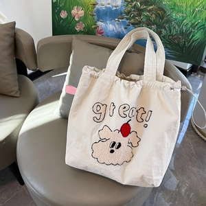 Off-white canvas tote bag featuring dog towel embroidery and drawstring closure