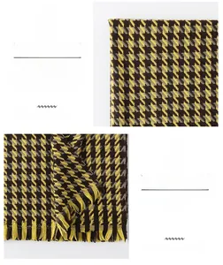 Detail of yellow and black houndstooth scarf with soft fringe and warm cashmere feel