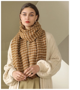 Detail of soft brown checkered scarf with fringe tassels and warm textured knit