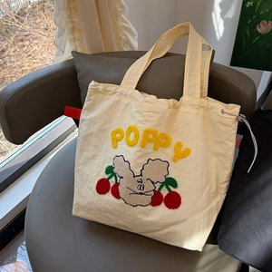 Creamy white canvas tote bag with yellow poppy embroidery and mouse cherry pattern