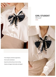 Detail of silk scarf tied as a bow on white shirt with letter print and floral pattern