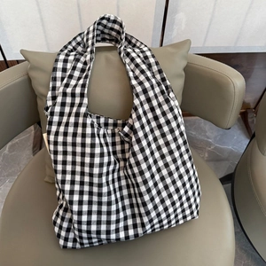Minimalist black and white plaid tote bag with spacious interior and soft fabric straps