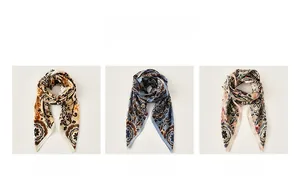 Detailed close-up of floral print silk scarves in yellow, blue and pink color variants