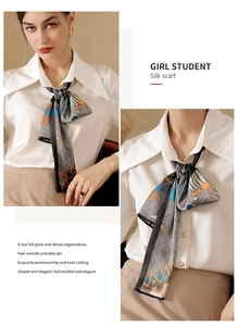 Détail de foulard en soie à motifs géométriques porté avec chemise blanche et jupe beige