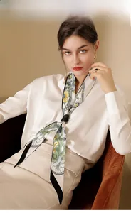 Elegant floral print silk scarf tied around neck styled with white satin blouse