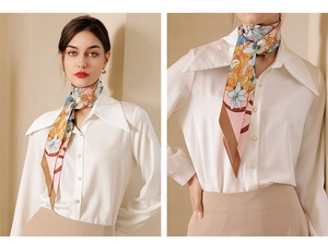 Detailed view of floral silk scarf styled on a neck over a white pearl button shirt