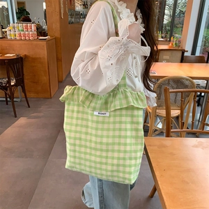 Green and white gingham tote bag with ruffle trim and Bisket brand label