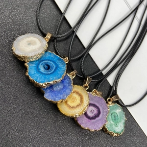 Set of colorful sliced geode sunflower pendants with gold-plated edges and black cord