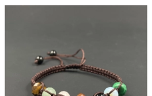 Detailed macro of a multi-color natural crystal bead bracelet with braided nylon cord