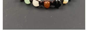 Macro shot of colorful faceted crystal beads woven into a dark brown cord bracelet