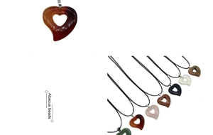 Macro detail of heart-shaped natural stone pendants including quartz and agate