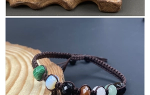 Macro shot of colorful faceted crystal beads on a brown braided cord over wood