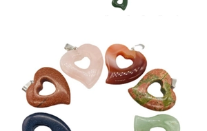 Macro view of assorted heart-shaped hollow gemstone pendants with silver clasps