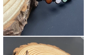 Macro detail of multicolored crystal beads and braided dark cord on wooden texture
