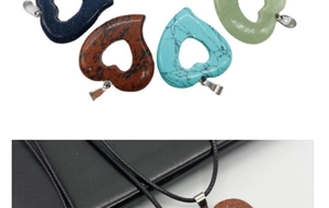 Macro detail of hollow heart gemstone pendants including turquoise and gold sandstone styles