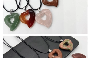 Detailed view of various heart-shaped natural stone pendants on black cords