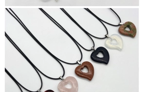 Collection of assorted heart-shaped gemstone pendants with black wax cord necklaces