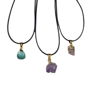 Set of three amethyst, rose quartz, and turquoise gemstone pendants on black cord necklaces