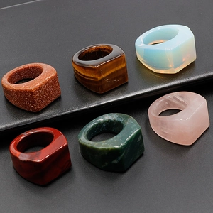 Set of 6 square natural gemstone rings including tiger eye and rose quartz on black stand