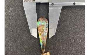 Macro shot of 15mm teardrop abalone shell pendant measured with a digital caliper