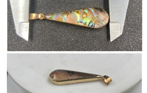 Macro detail of teardrop abalone shell pendant size measurement with gold-plated trim