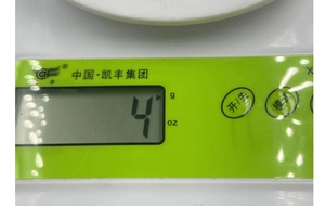 Macro detail of the green control panel on a digital scale with LCD and physical buttons