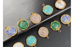 Detailed view of handmade gold wire wrapped round semi-precious gemstone pendants