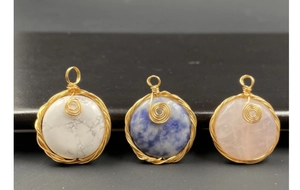 Detailed view of handmade copper wire wrapped semi-precious stone circular pendants