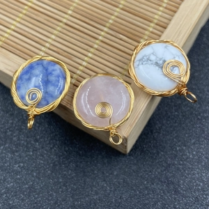 Handmade wire wrapped round semi-precious stone pendants in blue, pink, and white tones