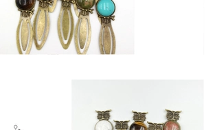 Detailed macro view of vintage bronze owl bookmarks with inlaid natural quartz stones