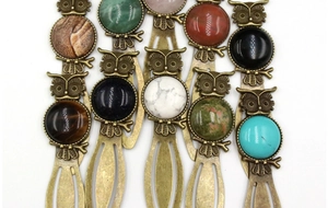 Detail of vintage owl bookmarks with various inlaid gemstones like tiger eye and agate