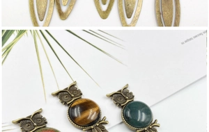 Macro detail of vintage owl bookmark with bronze finish and inlaid gemstone