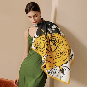 Luxurious faux silk scarf with large yellow floral prints and elegant gold trim