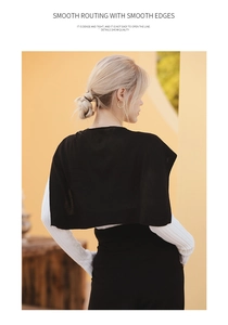 Detail of premium black knitted shawl showing the smooth routing and dense texture