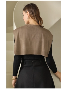 Rear view of brown knitted shawl with ribbed edges on black long-sleeve knitwear