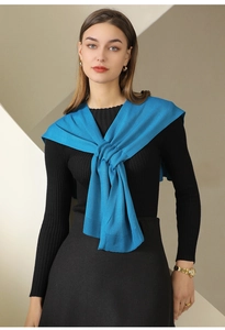Peacock blue knitted shawl with ribbed hem paired with an elegant black knit outfit